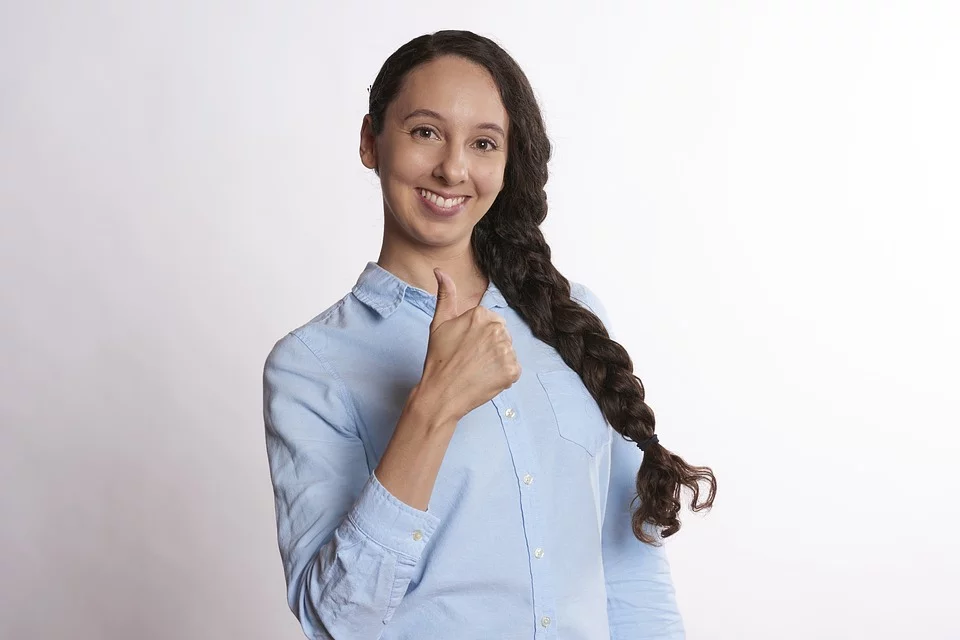 Person giving thumbs up, representing empowerment and positive outcomes